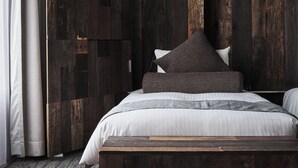 A bedroom with a bed, pillows, a wooden headboard, and a nightstand. - ONE＠Tokyo by insomnia (Tokyo)