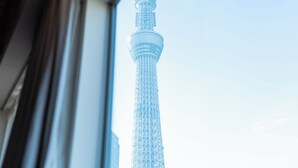 A view of the Tokyo Skytree through a window, featuring its distinctive spire and lattice structure. - ONE＠Tokyo by insomnia (Tokyo)