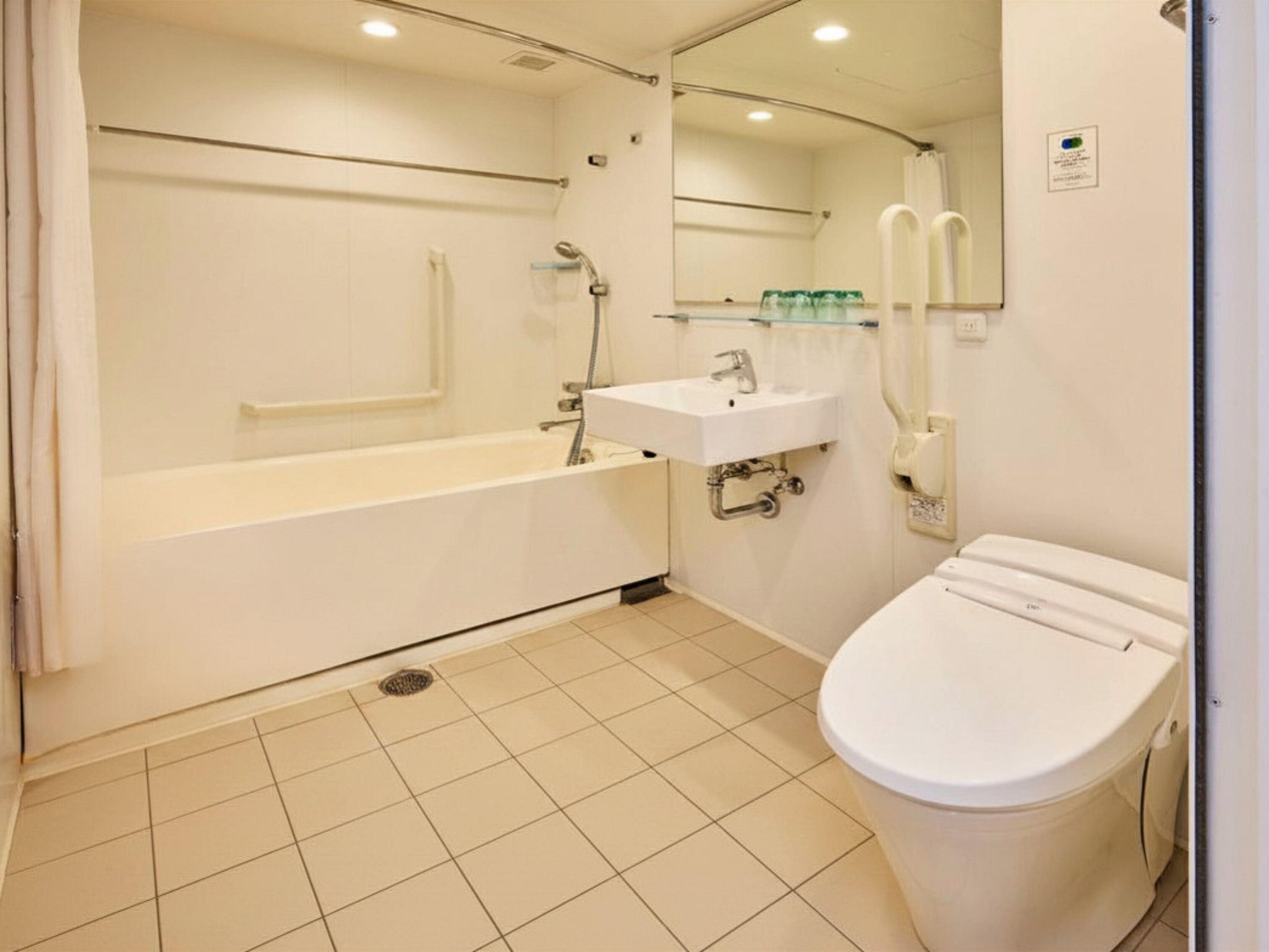 A bathroom with a bathtub, sink, and toilet.