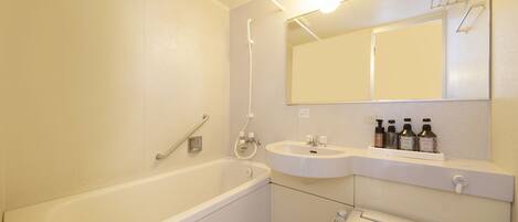 A bathroom with a bathtub, a sink, and a toilet.