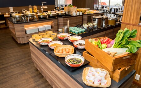 A buffet with various dishes and beverages.