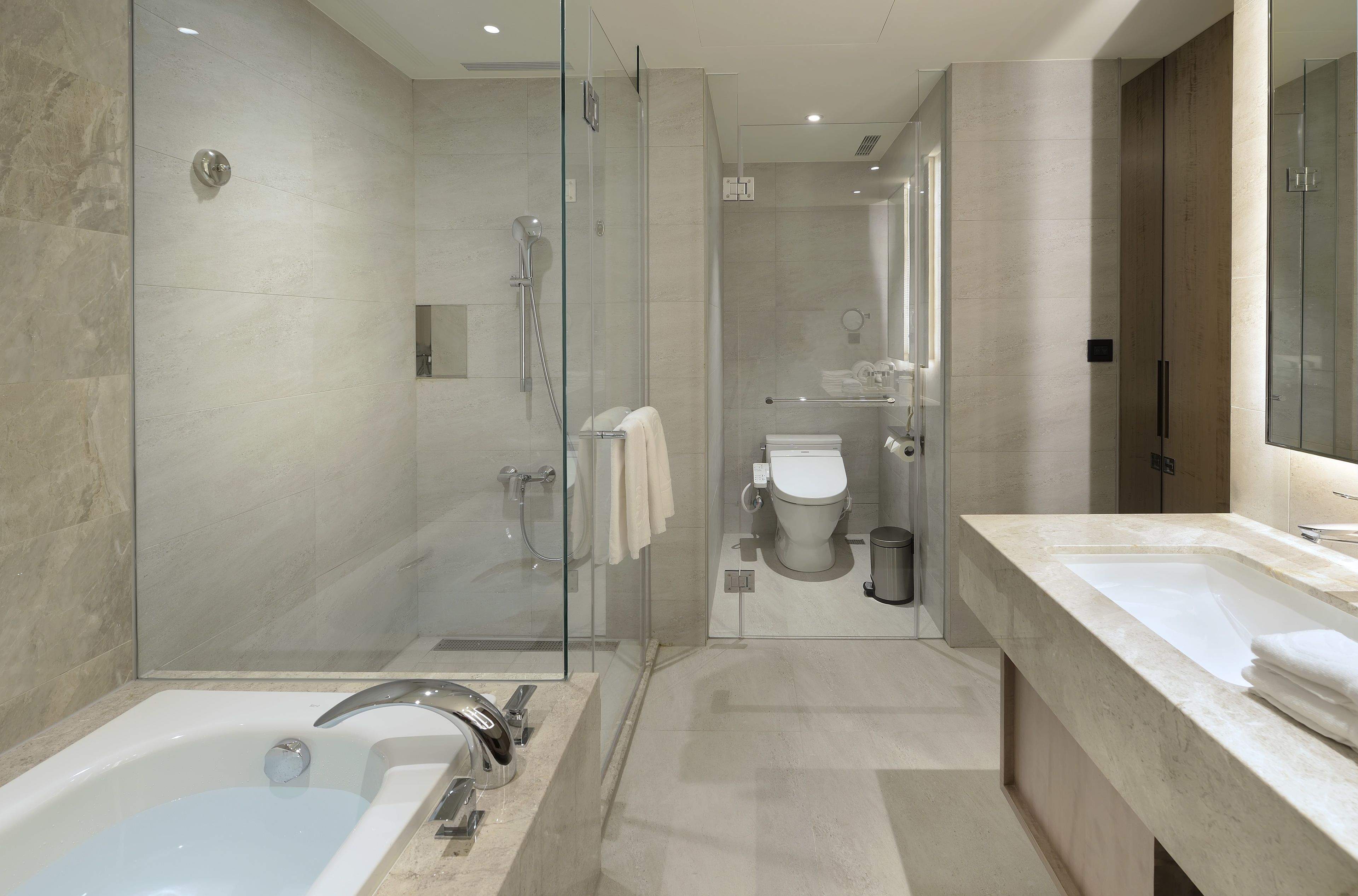 separate bathtub and shower, hair dryer, towels, shampoo