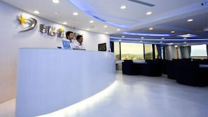 A modern reception area with a curved reception desk, a large window offering a view, and a logo on the wall. - Season Skyline (Luodong)