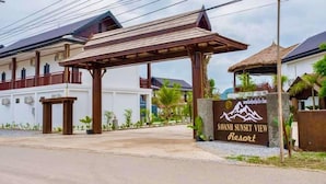 A resort entrance with a sign reading "Savannah Sunset View Resort".