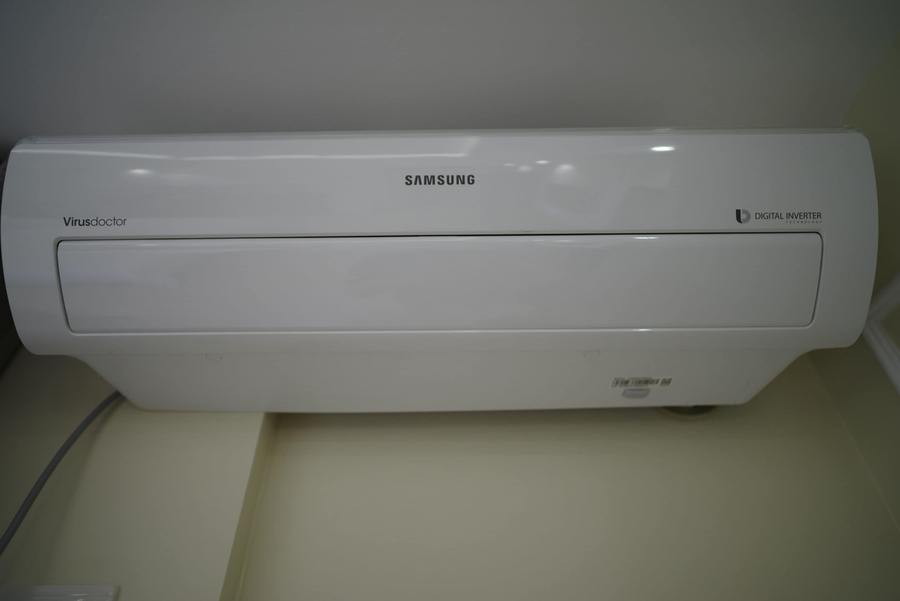A Samsung digital inverter refrigerator with a digital display, located in a kitchen setting.