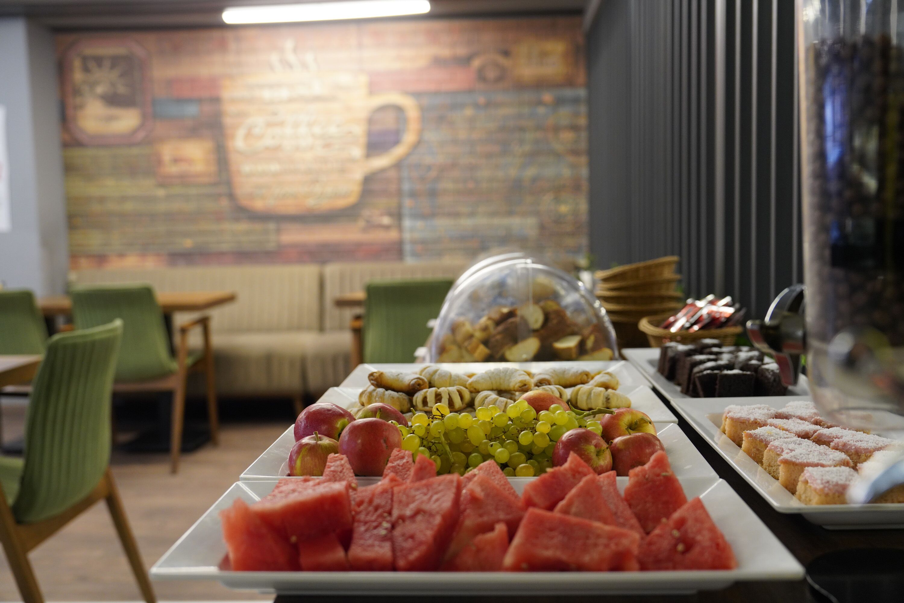 A buffet with various fruits and pastries.