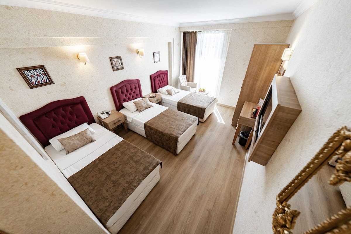 Standard Triple Room | Minibar, in-room safe, desk, soundproofing