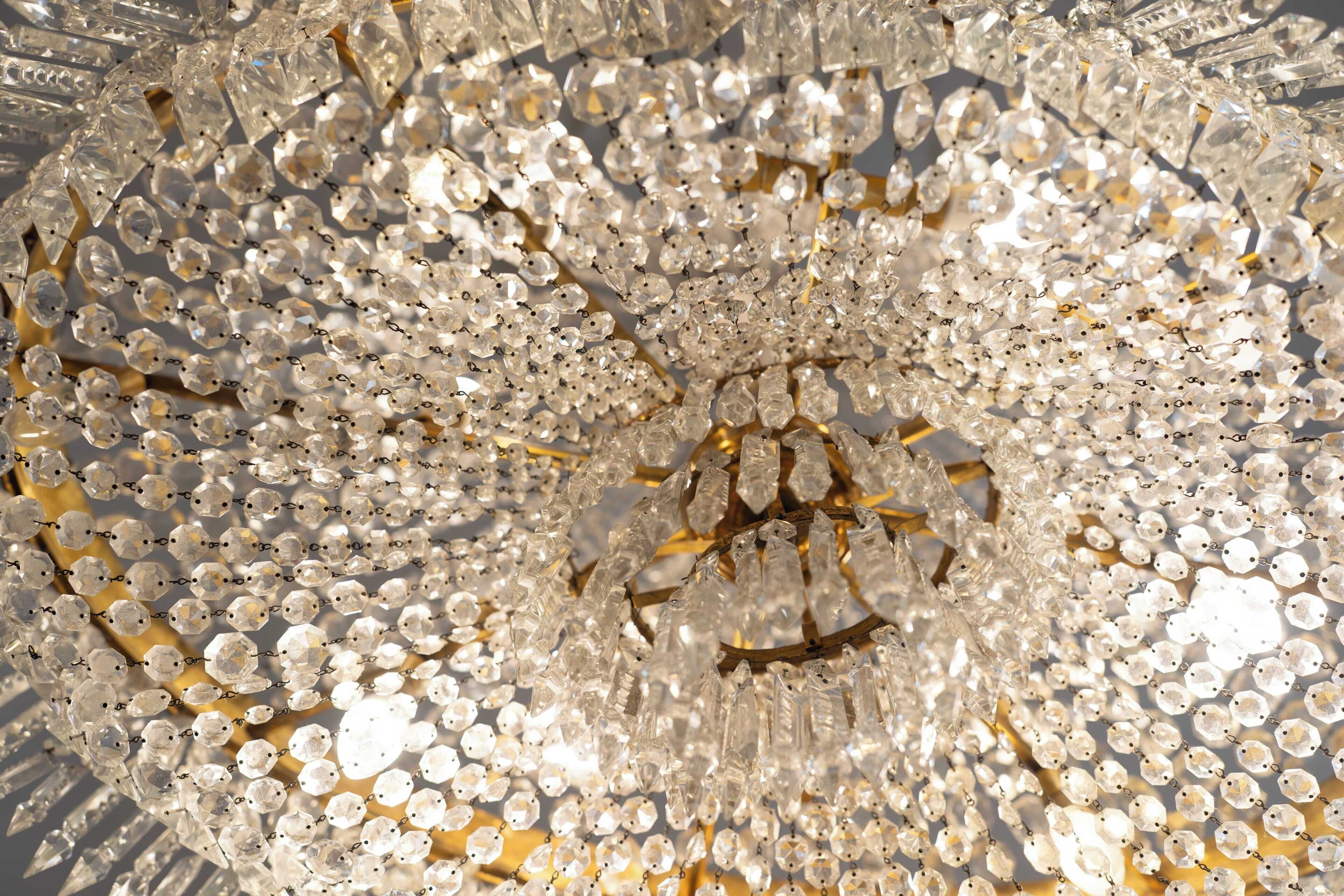 A chandelier with numerous clear crystal elements.