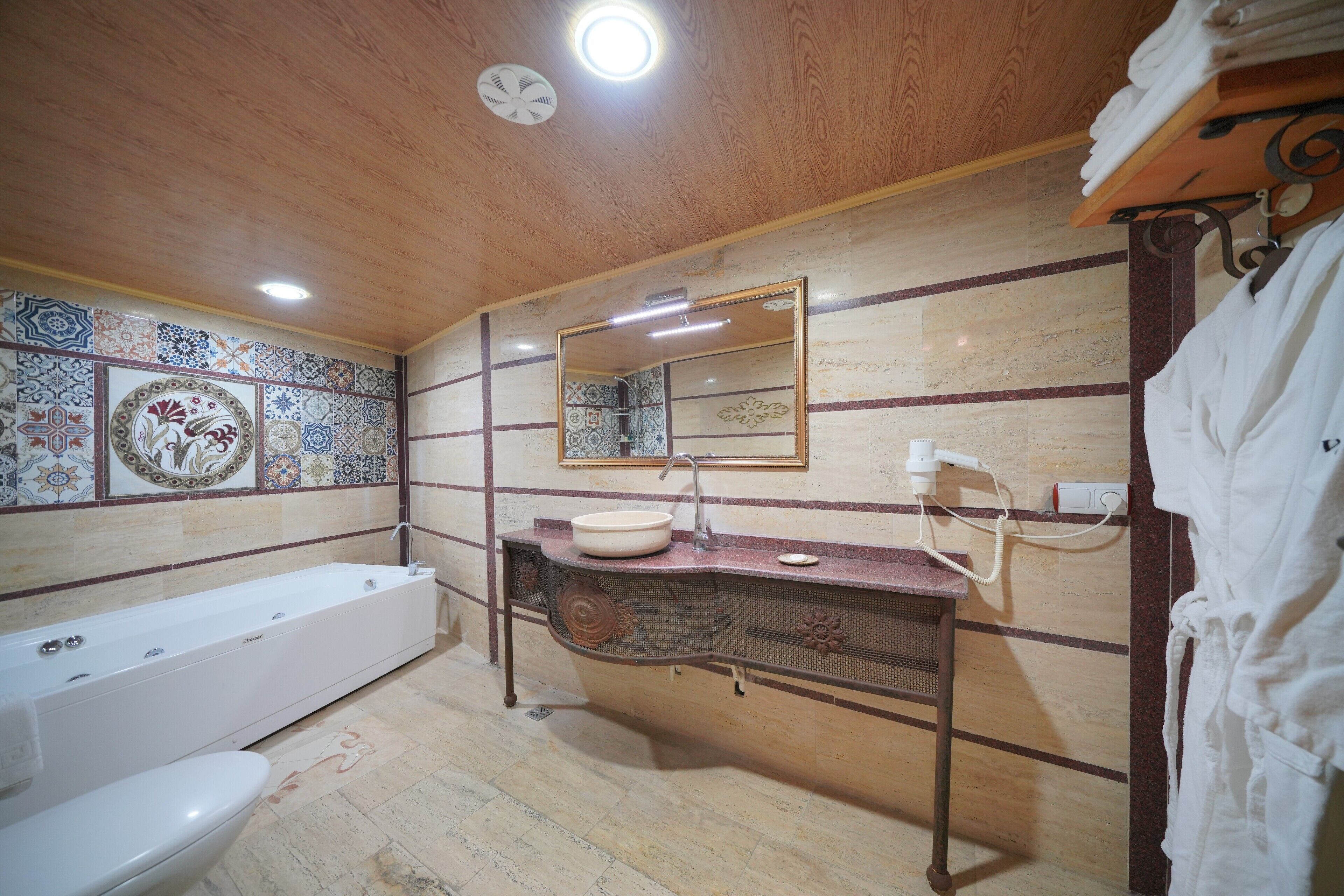 deluxe room (cave) | bathroom | eco-friendly toiletries, hair dryer, bathrobes, slippers