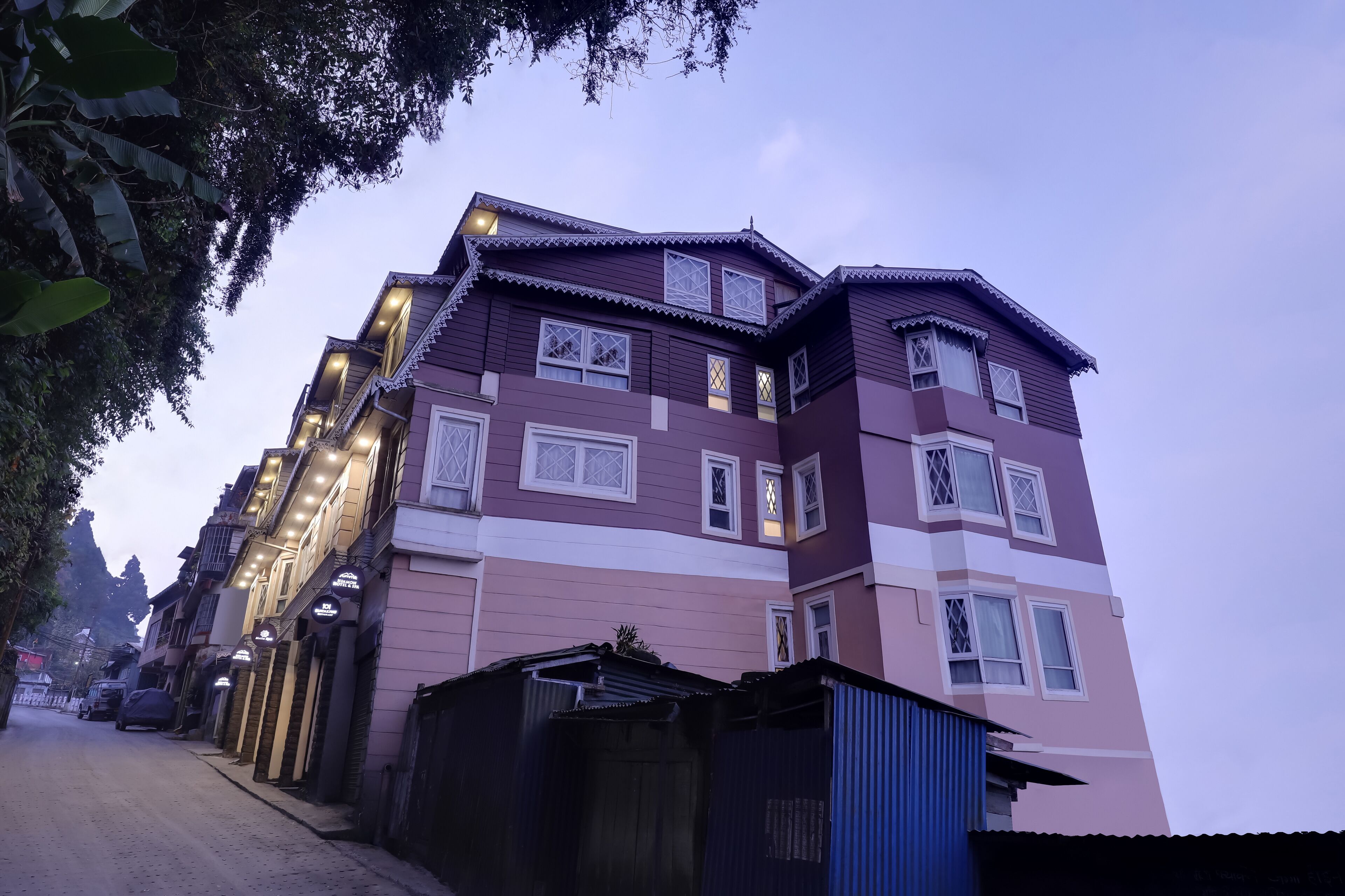 A multi-story building with a traditional architectural style, featuring balconies and multiple windows.