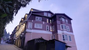 A multi-story building with a traditional architectural style, featuring balconies and multiple windows.