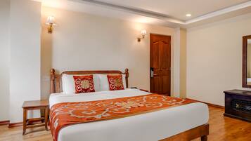 A neatly arranged bedroom with a wooden bed, a bedside table, and a nightstand.