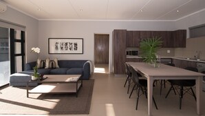 Een moderne woonkamer met een bank, salontafel en een eethoek met stoelen en een tafel. Er is een keuken met houten kastjes en een spoelbak.