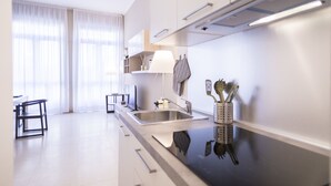 Deluxe Apartment (Traviata) | Private kitchen | Coffee/tea maker, fridge, stovetop, cookware/dishes/utensils - Hemeras Boutique House Aparthotel Piazza Diaz (Milan)