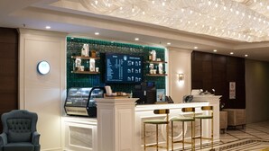 A modern hotel lobby with a reception desk, bar area, and seating. - Demircioğlu Park Hotel (Mugla)
