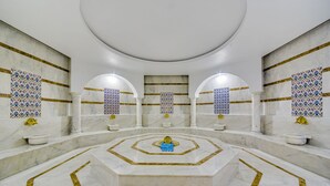 A luxurious bathroom with a central circular design, marble flooring, and decorative tiles on the walls. - Demircioğlu Park Hotel (Mugla)