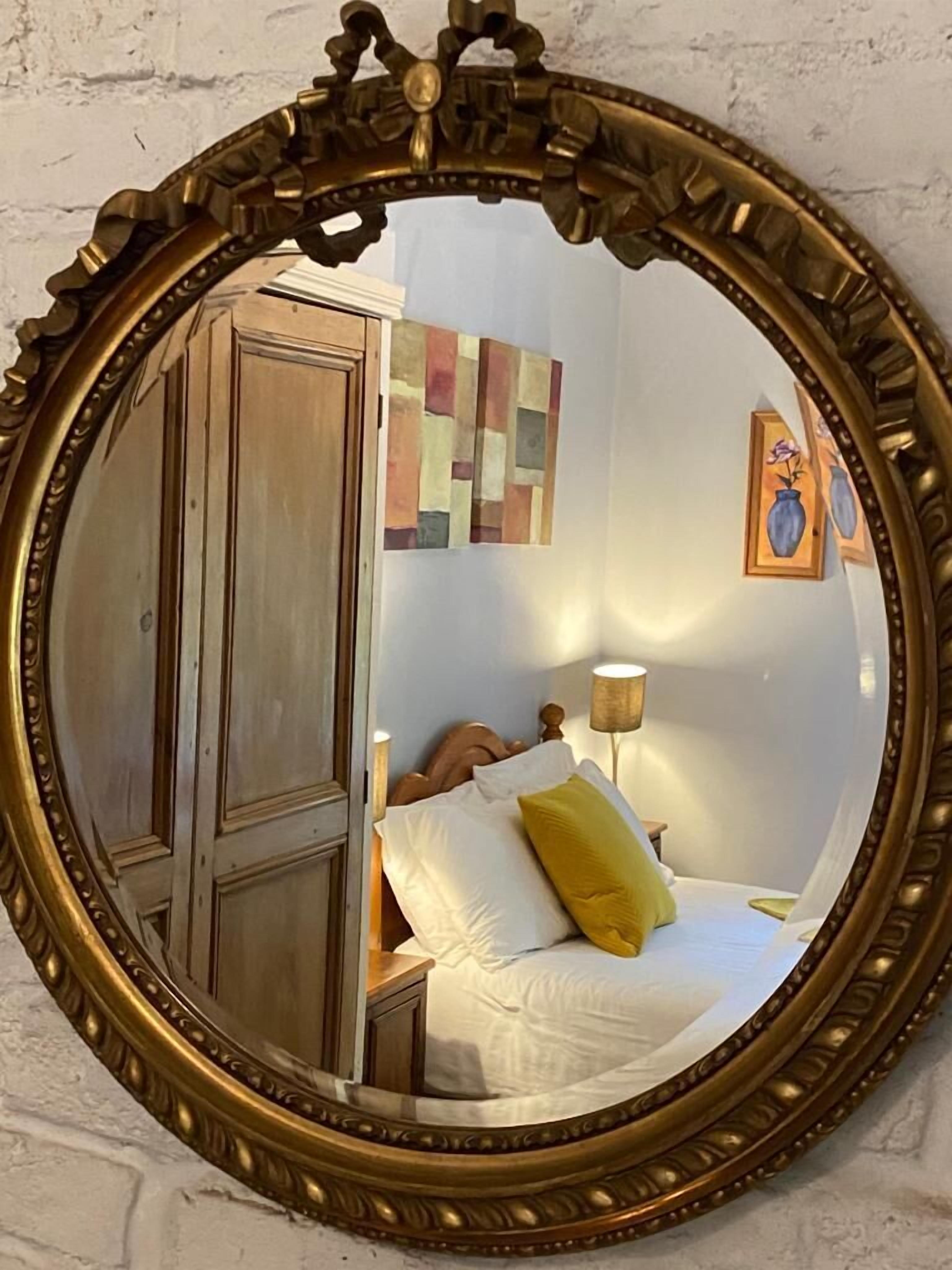 A bedroom with a bed, a nightstand, a lamp, and a wardrobe.