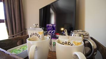 A tray with two white mugs labeled 'BORDEAU' and a silver coffee pot.