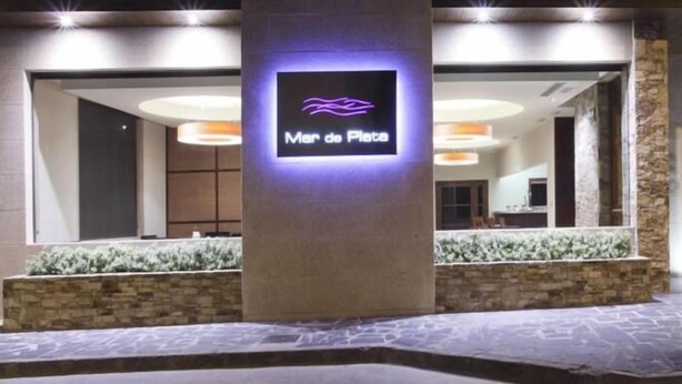 A hotel entrance with a neon sign reading "Mer de Plata" and a stone facade. - Hotel Mar de Plata (Sarria)