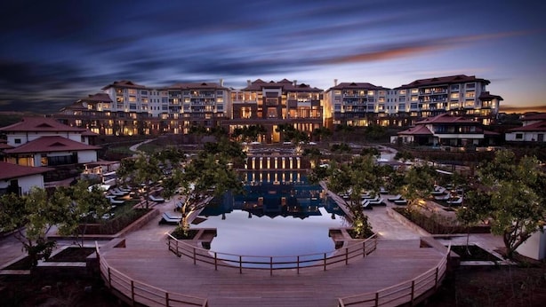 A resort with multiple buildings, a central pool, and a wooden deck. - Zimbali beach estate  (Ballito)
