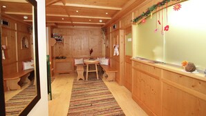 A wooden interior with a bench, a table, and a window with decorations. - Apartment in Kaltenbach near Ski Lift (Stumm)