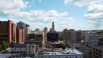 A cityscape with various buildings, including a prominent tall skyscraper and several mid-rise structures.