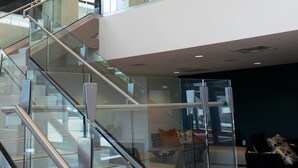 A modern interior with a glass staircase, a mezzanine level, and contemporary lighting fixtures. - Residence Inn Pittsburgh Oakland/University Place (Pittsburgh)