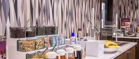 A breakfast buffet with various food items and beverages.