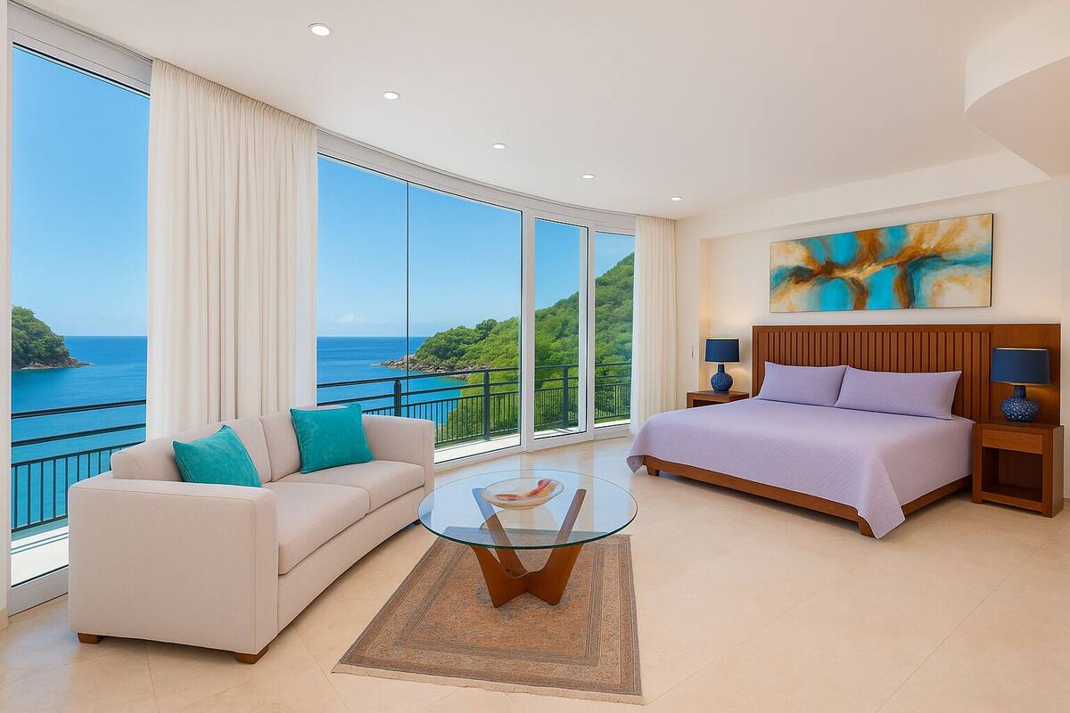 A hotel room with a large balcony, a bed, a sofa, and a glass coffee table.