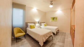 Deluxe Condo, 2 Bedrooms, Terrace, Partial Ocean View | 2 bedrooms, in-room safe, iron/ironing board, cribs/infant beds