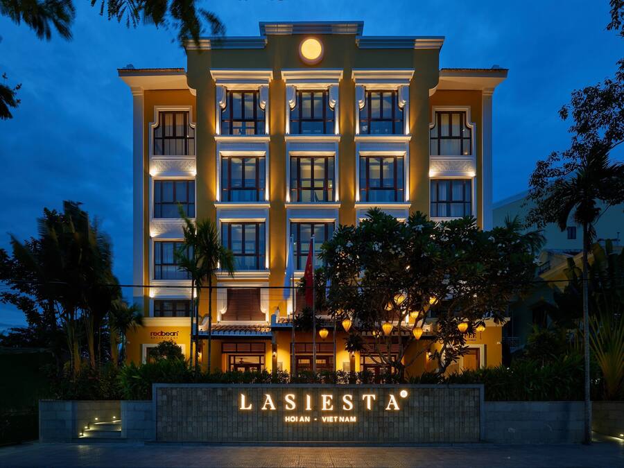 A hotel facade with a sign reading "LASIESTA HOIN - VIET NAM".