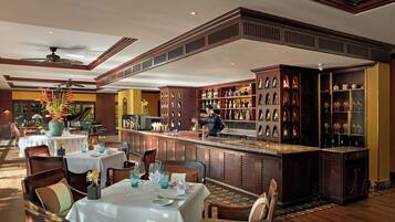 A restaurant with a bar area, wooden furniture, and a piano.