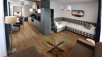 Grand Apartment, Kitchenette | Desk, blackout curtains, iron/ironing board, cots/infant beds