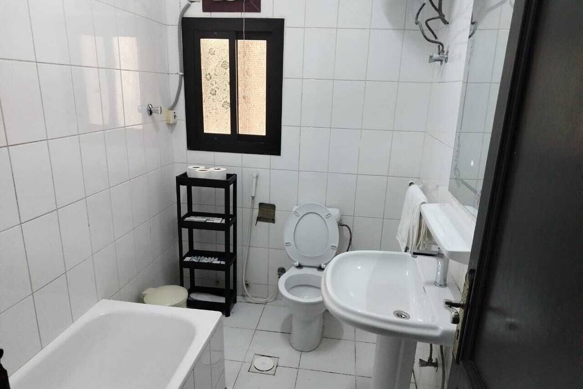 A bathroom with a bathtub, toilet, and sink.