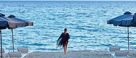 On the beach, sun loungers, beach umbrellas, beach towels