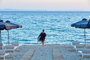 On the beach, sun-loungers, beach umbrellas, beach towels