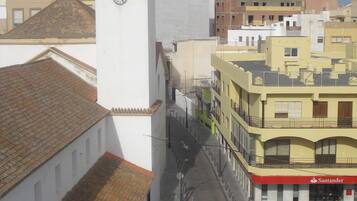 A street view with buildings, a clock tower, and a Santander bank.
