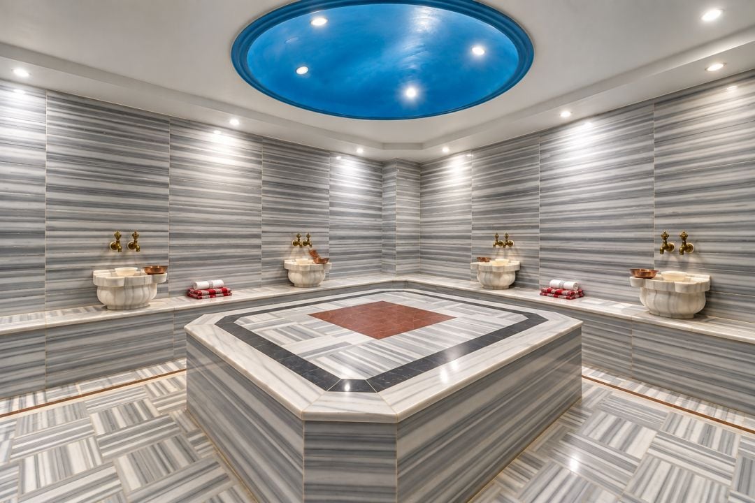 A modern bathroom with a central island, multiple sinks, and a unique ceiling design.