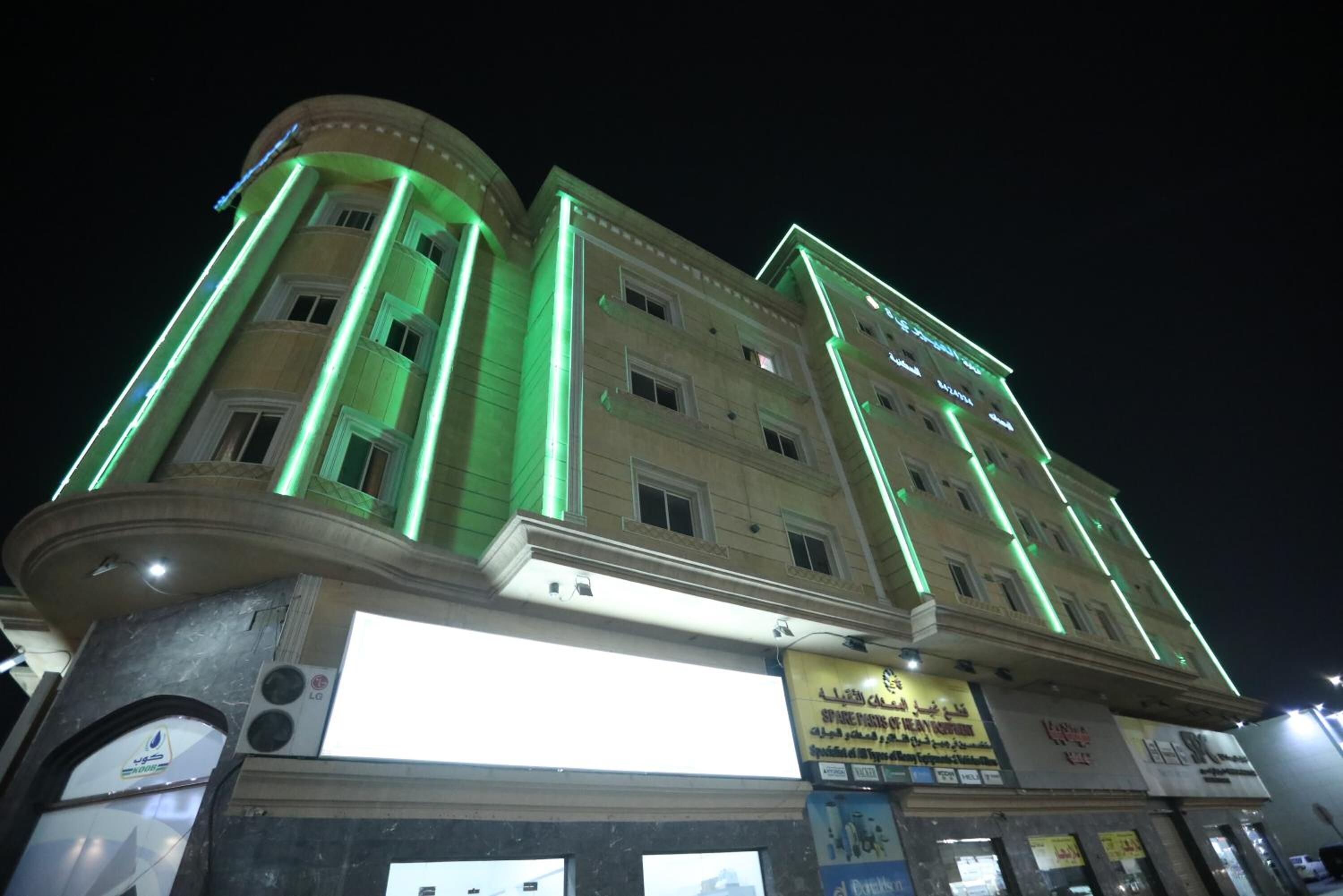 A multi-story building with a prominent entrance and signage.