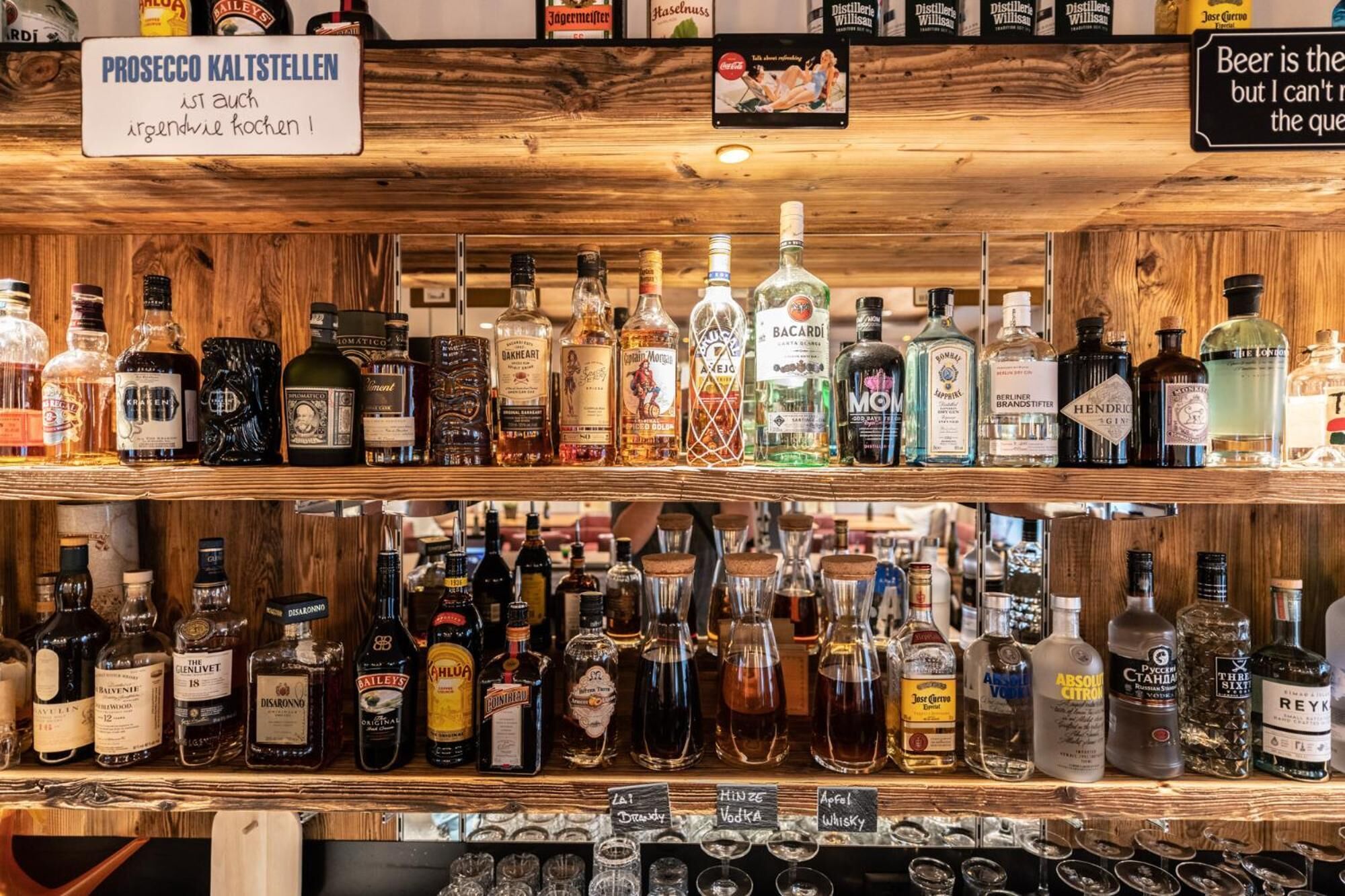 A bar with various liquor bottles and glasses.