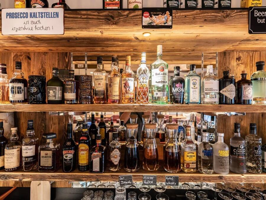 A bar with various liquor bottles and glasses.