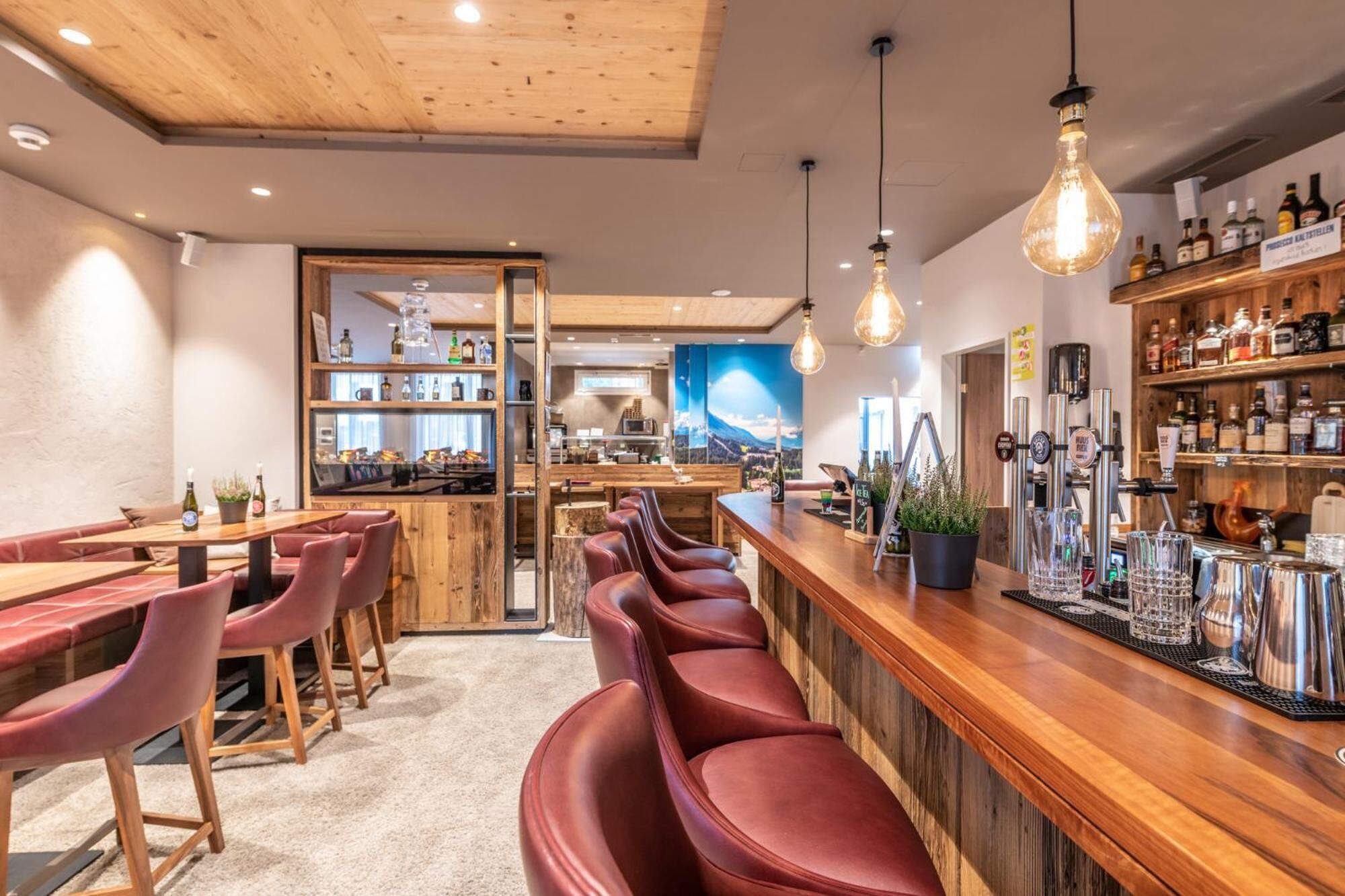 A bar area with wooden furniture, a bar counter, and a beer tap.