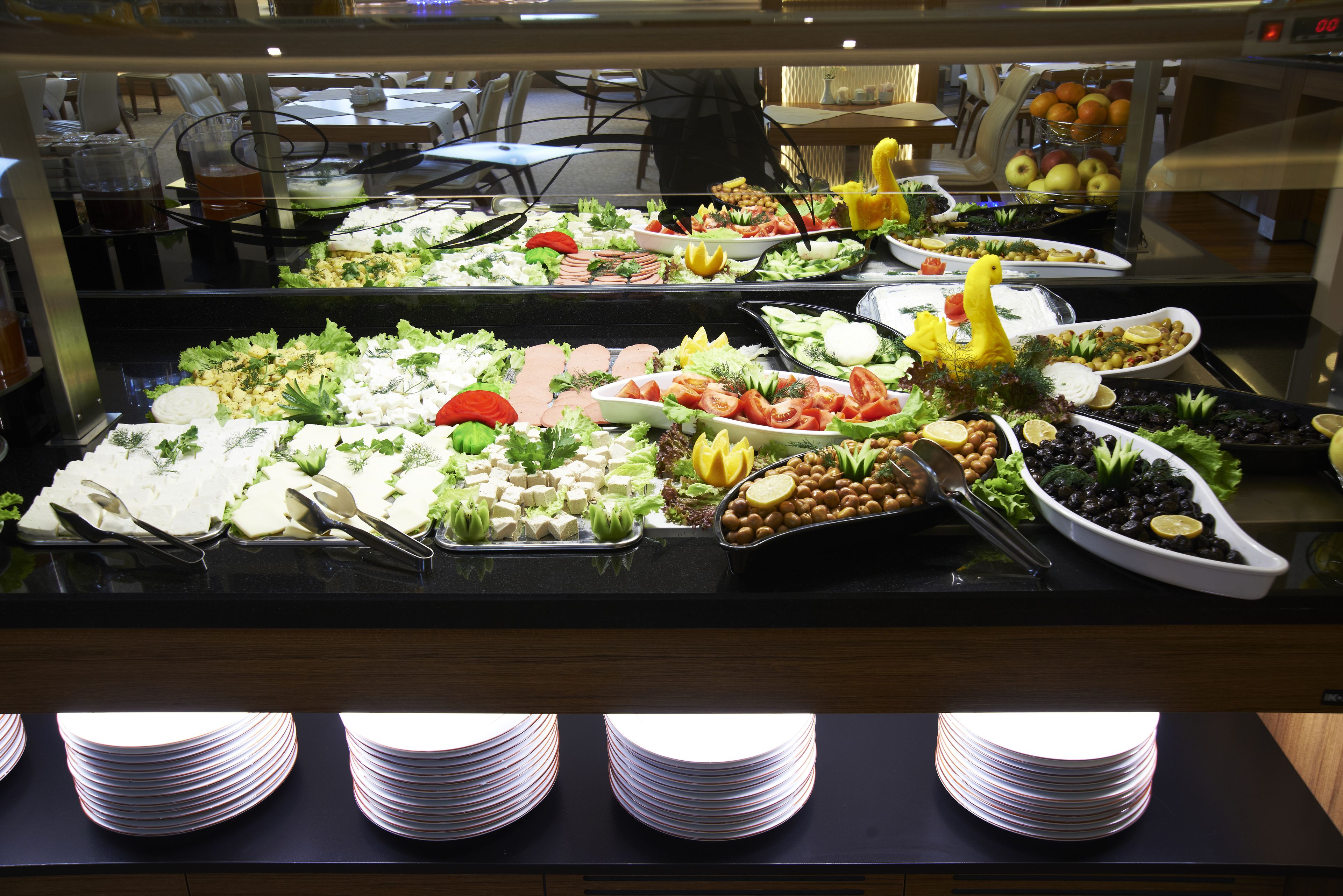 A buffet with various food items and utensils.