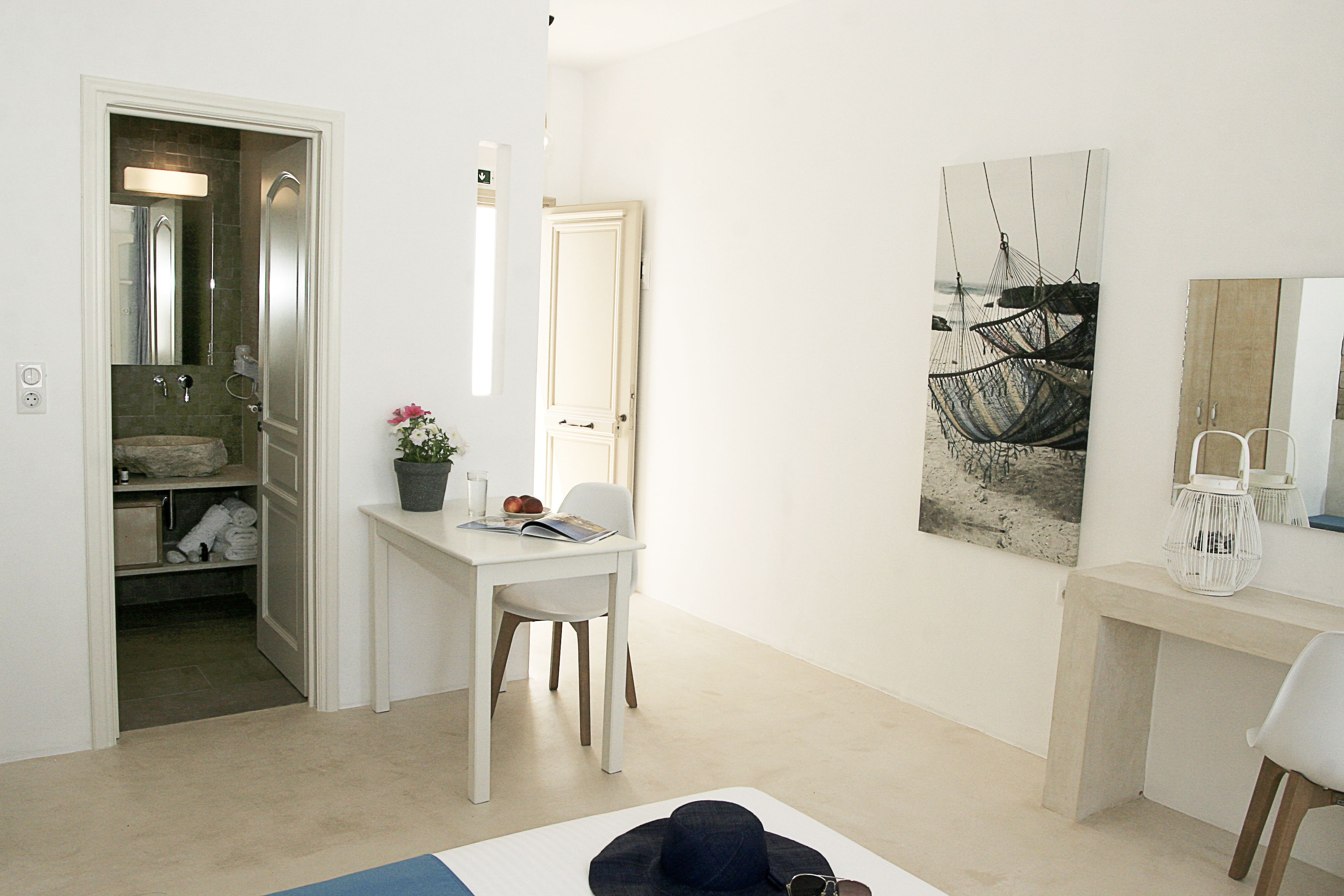 A modern bathroom with a shower, a vanity with a mirror, and a towel rack.