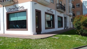 A building with storefronts labeled "CREDENCIAL". - Albergue Credencial - Hostel (Sarria)
