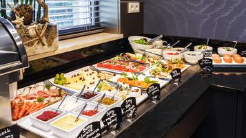 A buffet with various food items and condiments.