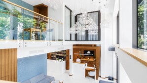 A modern hotel lobby with a reception desk, seating area, and a bar. - Hotel Testa (Sopot)