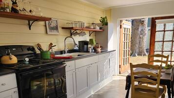 Deluxe Cottage, 1 King Bed, Garden View, Ground Floor | Private kitchen | Fridge, microwave, coffee/tea maker, toaster