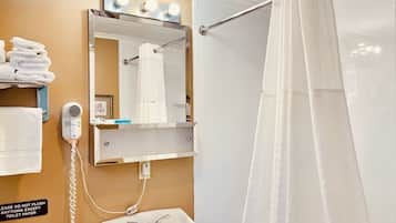 A bathroom with a sink, mirror, towel rack, and a shower curtain.