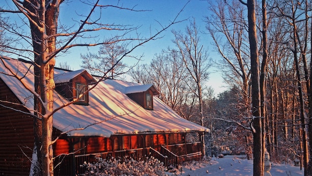 A cabin with a snow-covered roof, surrounded by trees and bushes. - Barefoot Hills (Dahlonega)